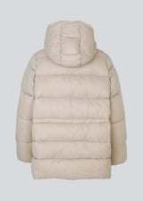 Puffer jacket with an oversized silhouette and adjustable drawstring waist. StellaMD jacket is designed with a high-standing collar, hood, two-way zipper and paspel pockets.