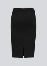 Simple, stylish and a must-have tight skirt. Tanny skirt is knee length and has a small slit at the back. The stretchable material creates a perfect fit. The model is 174 cm and wears a size S/36
