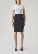Simple, stylish and a must-have tight skirt. Tanny skirt is knee length and has a small slit at the back. The stretchable material creates a perfect fit. The model is 174 cm and wears a size S/36