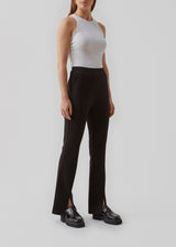 Nice pants in a soft quality with stretch. Tanny slit pants has a simple design with an elasticated waistline and a tight fit. The slit detail at the hem creates more width and effect at the bottom.