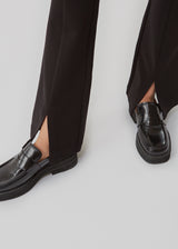 Nice pants in a soft quality with stretch. Tanny slit pants has a simple design with an elasticated waistline and a tight fit. The slit detail at the hem creates more width and effect at the bottom.