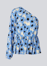 Top with one balloon sleeve with elastic cuff. TorahMD print one shoulder top has a relaxed fit with elasticated cutline at the waist.