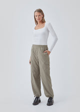 Cargo pants in nylon with elastic waistline and adjustable hems with elastic drawstrings. TrentMD pants have patch pockets on the legs. In Spring Stone.  This is the same model as our popular pants AmayaMD pants. Just in a thicker material, perfect for fall and winter.