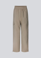 Cargo pants in nylon with elastic waistline and adjustable hems with elastic drawstrings. TrentMD pants have patch pockets on the legs. In Spring Stone.  This is the same model as our popular pants AmayaMD pants. Just in a thicker material, perfect for fall and winter.