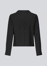 Shirt with long sleeves in Eco Vero viscose quality. TrudaMD shirt has a collar and opening in front with tied fastening in front.