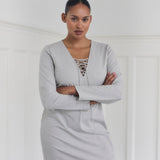 Short fitted dress with a v-neck with a lace-up detail. MickyMD dress has long sleeves and a zipper in the side.
