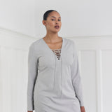 Short fitted dress with a v-neck with a lace-up detail. MickyMD dress has long sleeves and a zipper in the side.