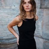 Tight fit basic black top with a high and straight neckline. DaeMD top is made from a rib-knitted organic cotton. The model is 177 cm and wears a size S/36.
