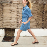Short denim playsuit with a tieband in 100% organic cotton. NaomaMD solid playsuit has a button closure in front, a shirt collar, and side pockets.