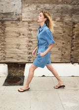 Short denim playsuit with a tieband in 100% organic cotton. NaomaMD solid playsuit has a button closure in front, a shirt collar, and side pockets.