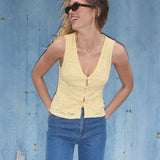 Sleeveless lace top in yellow with a v-neck. MamumdMD top is fitted and has a button closure in front.
