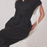 Black jumpsuit with wide legs and a tieband at the waist. NedraMD jumpsuit has a collar, v-neck, and a zipper at front.
