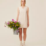 Short sleeveless dress in linen and cotton. IngridMD dress has a v-neckline and raw edges in front and at the bottom.