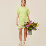 Fitted mini dress in green with an elastic gathering on the side. IbiMD dress has an invisible zipper in the back.