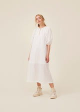 Maxi dress in broderie anglaise. IrsaMd dress has a relaxed fit, puff sleeves and a opening in front with a button closure.
