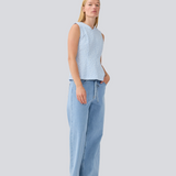 Tailored top without sleeves made from a structured material. HollisMD top has a high v-shaped neckline with a hidden zipper at the neck.