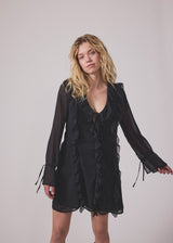 Short black dress with frill details and a loose fit. NorrisMD dress has a v-neck and long, wide sleeves with tiebands.