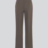 Classic pants in brown with pressfolds and straight legs. Nelli pants are closed by an hidden zipper at the side with an elastic waistband for a more comfortable fit.&nbsp;