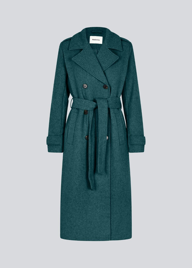 Classic, double-breasted wool coat with collar and notch lapels. ShayMD coat has a wide tiebelt at waist, shoulder straps, wide cuffs and open yoke. With lining and single back vent.