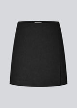 Classic A-line black skirt in short length. GaleMD skirt has a simple expression with a hidden zip at the side seam and a slit in front.&nbsp;