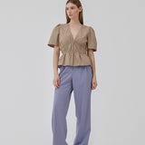 Beige top made from a cotton mix with short, slightly puffed, sleeves, and a deep v-neckline. DeenMD top has a flattering ruched detail below the chest and at the waist. The model is 177 cm and wears a size S/36.