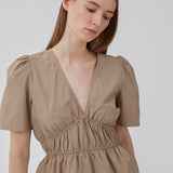 Beige top made from a cotton mix with short, slightly puffed, sleeves, and a deep v-neckline. DeenMD top has a flattering ruched detail below the chest and at the waist. The model is 177 cm and wears a size S/36.