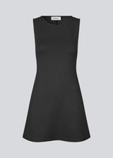 Fitted black mini dress in an A-line shape with a round neck and no sleeves. JosefineMD tank flare dress is made from a stretchy material. The model is 177 cm and wears a size S/36.