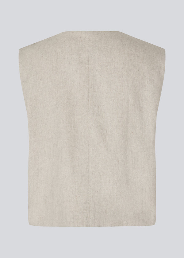 Short beige waistcoat in a woven linen blend in beige. ParkMD vest has a deep v-neck with buttons and a relaxed and loose silhouette.&nbsp;