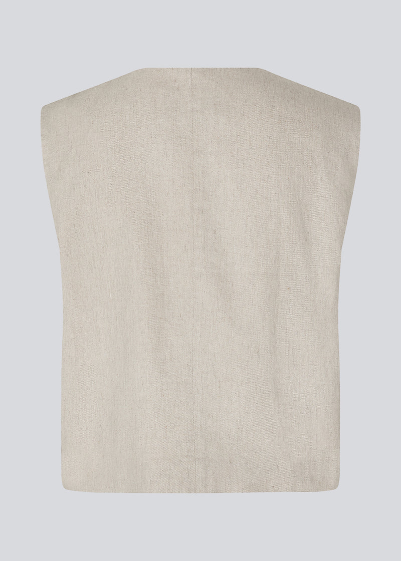 Short beige waistcoat in a woven linen blend in beige. ParkMD vest has a deep v-neck with buttons and a relaxed and loose silhouette.&nbsp;