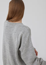 Oversized fluffy knitted jumper in grey melange in woven from a wool and alpaca blend. TalaMD o-neck has a round neck, dropped shoulders and a longer back. Ribknitted trims on neck, sleeves and hem.&nbsp;<br>