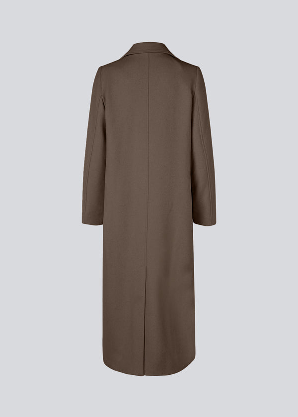 Classic, double-breasted wool coat with collar and notch lapels. JuniperMD coat has a relaxed fit, lining and a slit in the back.
