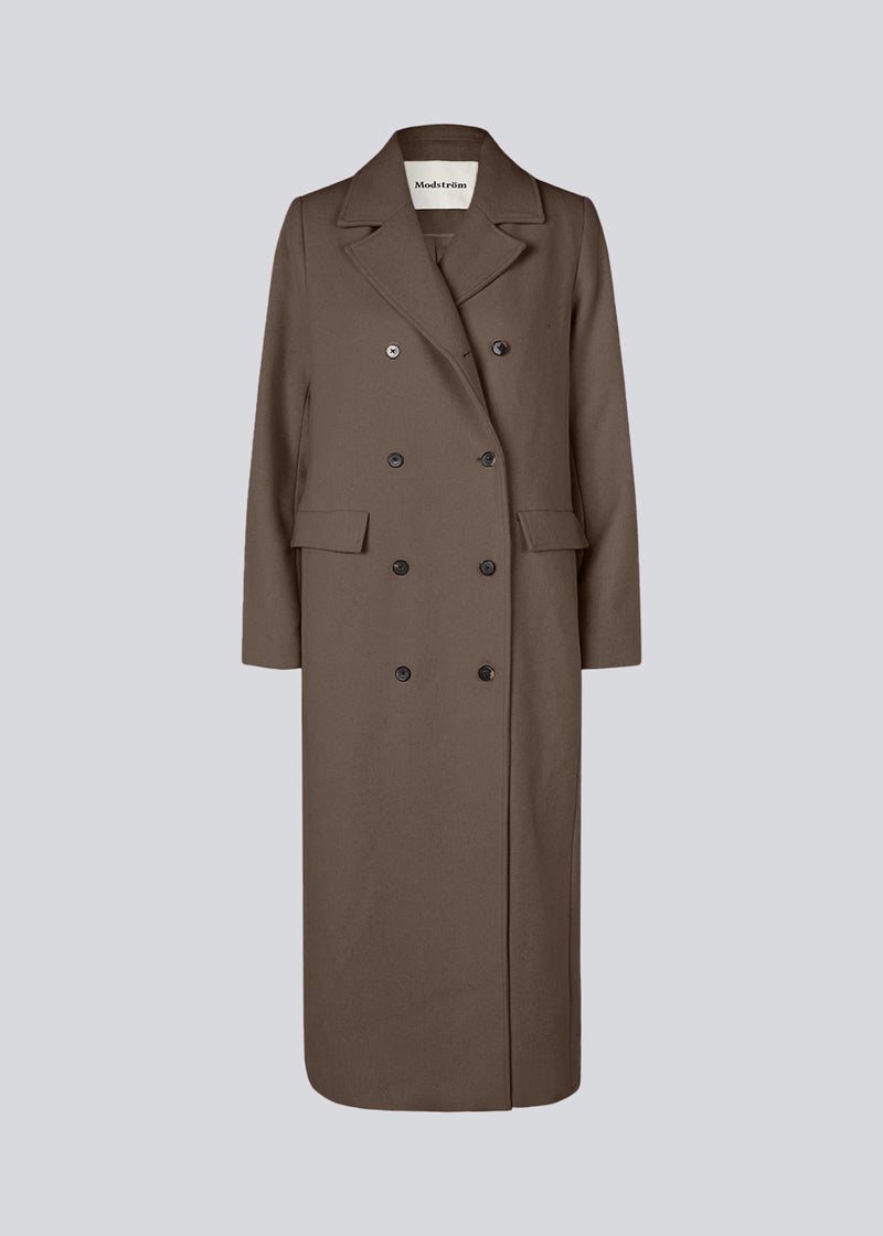 Classic, double-breasted wool coat with collar and notch lapels. JuniperMD coat has a relaxed fit, lining and a slit in the back.