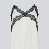 Satin top with a soft drape in white with black lace. TenjaMD top is detailed with lacing on the front and has thin straps.