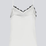 Satin top with a soft drape in white with black lace. TenjaMD top is detailed with lacing on the front and has thin straps.