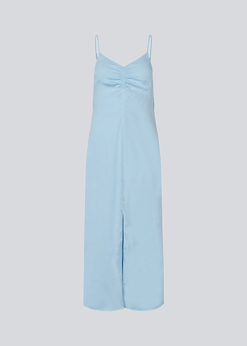 Maxi dress in baby blue with thin straps and an elastic gathering at the chest. TrentonMD print dress has a slit in the front and an invisible zipper at the back.<br>