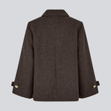 Classic short jacket in a wool mix. Ofiamd jacket has a relaxed fit, hidden button closure and collar. The model is 175 cm and wears a size s/36.