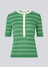 Short-sleeved polo in shimmery knit in the color Medium Green Stripe. Pacifico SS polo has a tight fit and a placket with 5 buttons. The model is 175 cm and wears a size s/36.