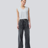 Black jeans with wide legs in cotton denim. IsoldeMD pants has a high waist, front and back pockets, and a tie band at the waist. The model is 175 cm and wears a size S/36.