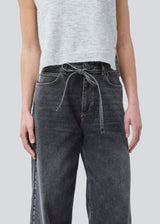 Black jeans with wide legs in cotton denim. IsoldeMD pants has a high waist, front and back pockets, and a tie band at the waist. The model is 175 cm and wears a size S/36.