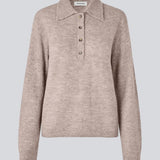 Knitted polo in beige with long sleeves. Treemd polo has a placket closure and 4 buttons.&nbsp;