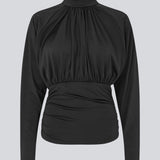 Elegant black blouse featuring a high neckline and long sleeves. Designed with delicate gathered details at the bust and waist to create a flattering silhouette. A subtle button closure at the back of the neck adds a refined and feminine touch. The stretchy fabric ensures a comfortable fit, while the draped design offers timeless elegance. Perfect for both everyday wear and special occasions.