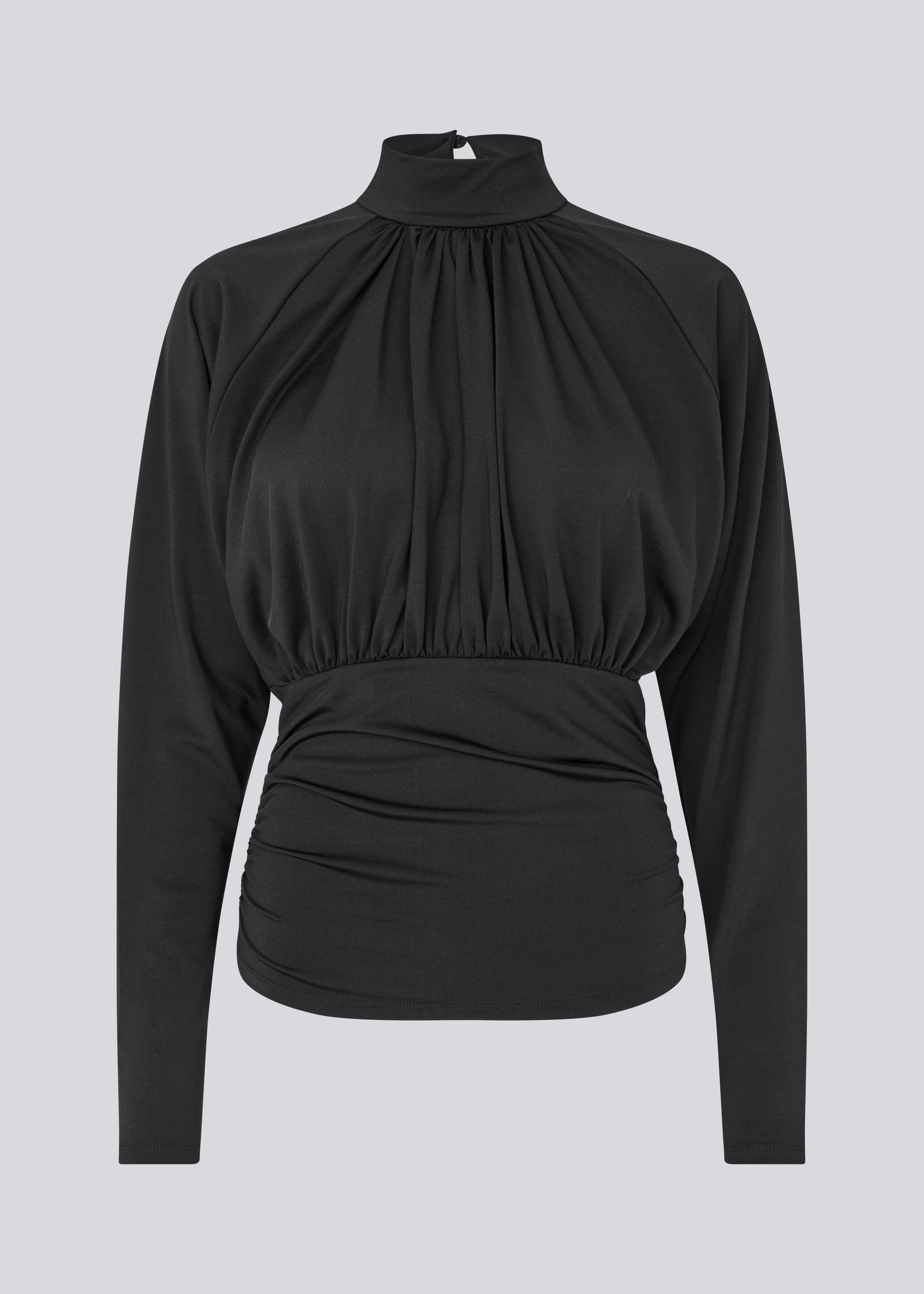 Elegant black blouse featuring a high neckline and long sleeves. Designed with delicate gathered details at the bust and waist to create a flattering silhouette. A subtle button closure at the back of the neck adds a refined and feminine touch. The stretchy fabric ensures a comfortable fit, while the draped design offers timeless elegance. Perfect for both everyday wear and special occasions.