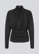 Elegant black blouse featuring a high neckline and long sleeves. Designed with delicate gathered details at the bust and waist to create a flattering silhouette. A subtle button closure at the back of the neck adds a refined and feminine touch. The stretchy fabric ensures a comfortable fit, while the draped design offers timeless elegance. Perfect for both everyday wear and special occasions.