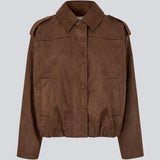 Short brown jacket made from a soft, suede-like material. Features a classic shirt collar, hidden zip and button closure at the front, and practical front pockets. The structured shoulders with strap details and the slightly elasticated hem add a modern, tailored touch. A versatile and stylish piece, perfect for transitional weather and everyday wear.