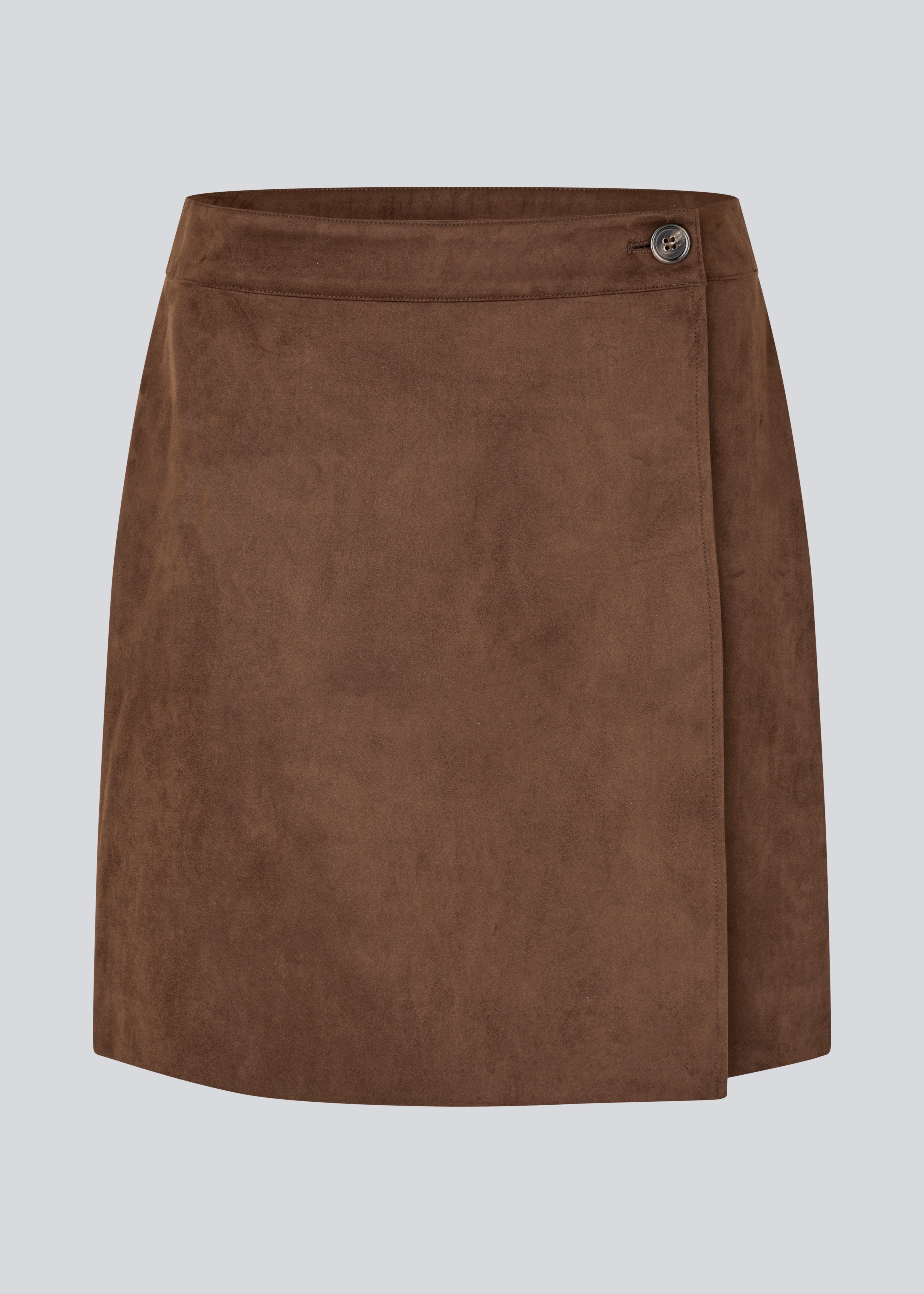 Short brown skirt in a suede-look fabric featuring an elegant wrap design. Closes with a decorative side button, adding a sleek and feminine touch. The soft material ensures a comfortable fit, while the minimalist cut makes it easy to style for both casual and more formal occasions. 