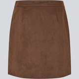 Short brown skirt in a suede-look fabric featuring an elegant wrap design. Closes with a decorative side button, adding a sleek and feminine touch. The soft material ensures a comfortable fit, while the minimalist cut makes it easy to style for both casual and more formal occasions. 