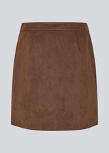 Short brown skirt in a suede-look fabric featuring an elegant wrap design. Closes with a decorative side button, adding a sleek and feminine touch. The soft material ensures a comfortable fit, while the minimalist cut makes it easy to style for both casual and more formal occasions. 