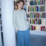 Classic shirt in the color Medium Green Stripe with an opening in the back and bow details. MilleMD stripe shirt has a oversize fit and a cuff with button closure. The model is 177 cm and wears a size S/36.