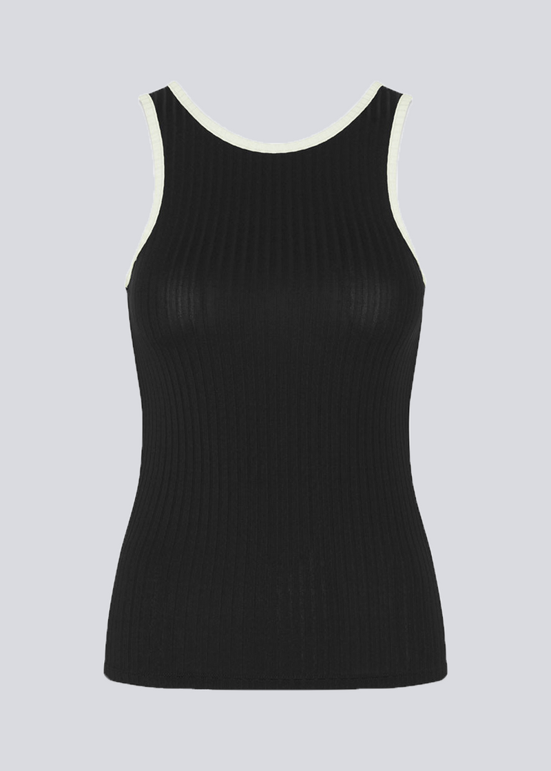 Tight-fitted black sleeveless top in a stretchy material with a round neck cutting lower on the back. FaizMD top has contrasting bias tape. 