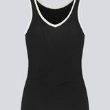 Tight-fitted black sleeveless top in a stretchy material with a round neck cutting lower on the back. FaizMD top has contrasting bias tape. 